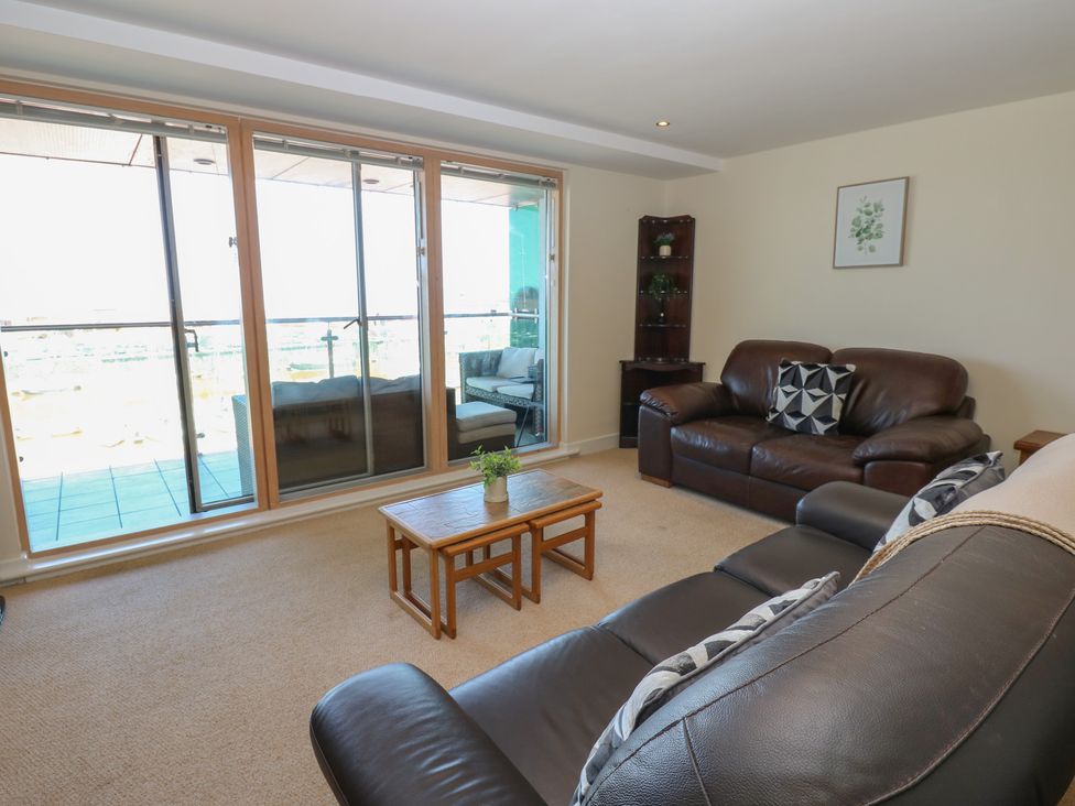 A living room with a coffee table and two sofas at Pears Suite in Whitehaven