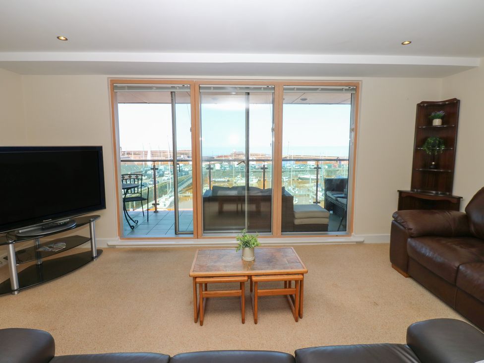 A living room with a television and sofa at Pears Suite in Whitehaven