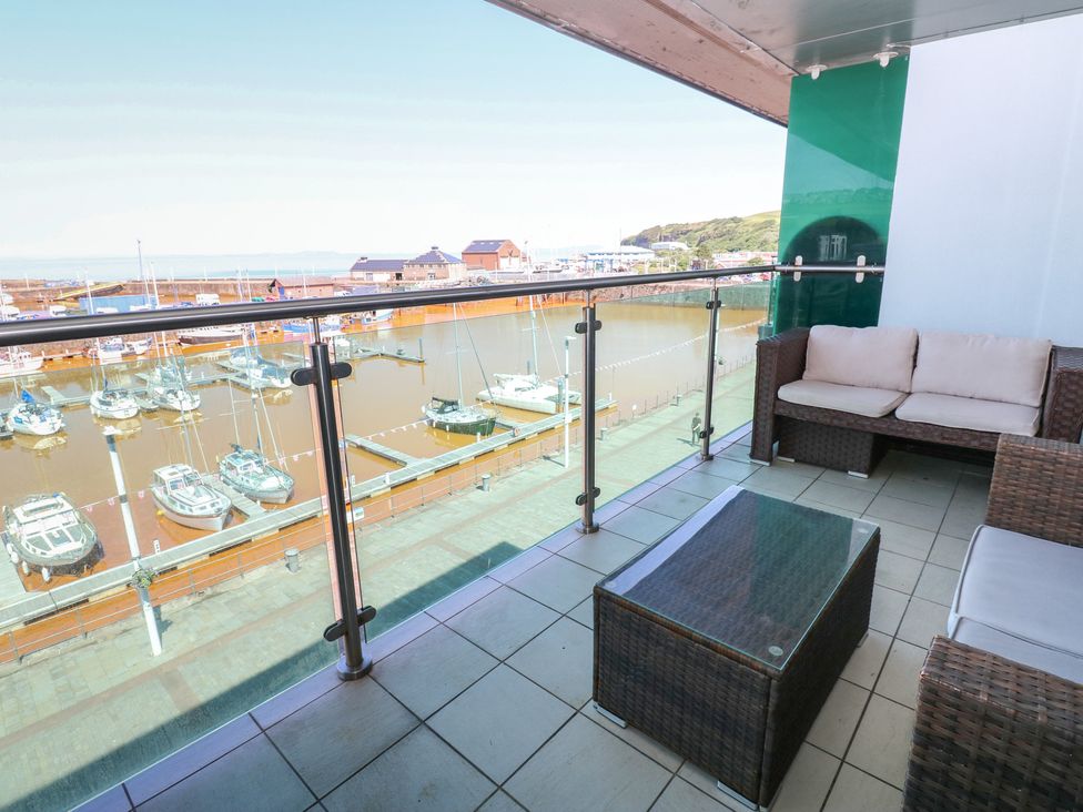 A balcony overlooking a marina with boats at Pears Suite Whitehaven