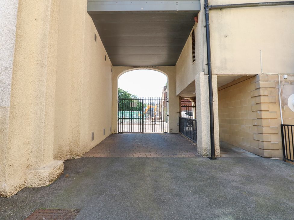 An archway leading to a gated outdoor area at Pears Suite Whitehaven