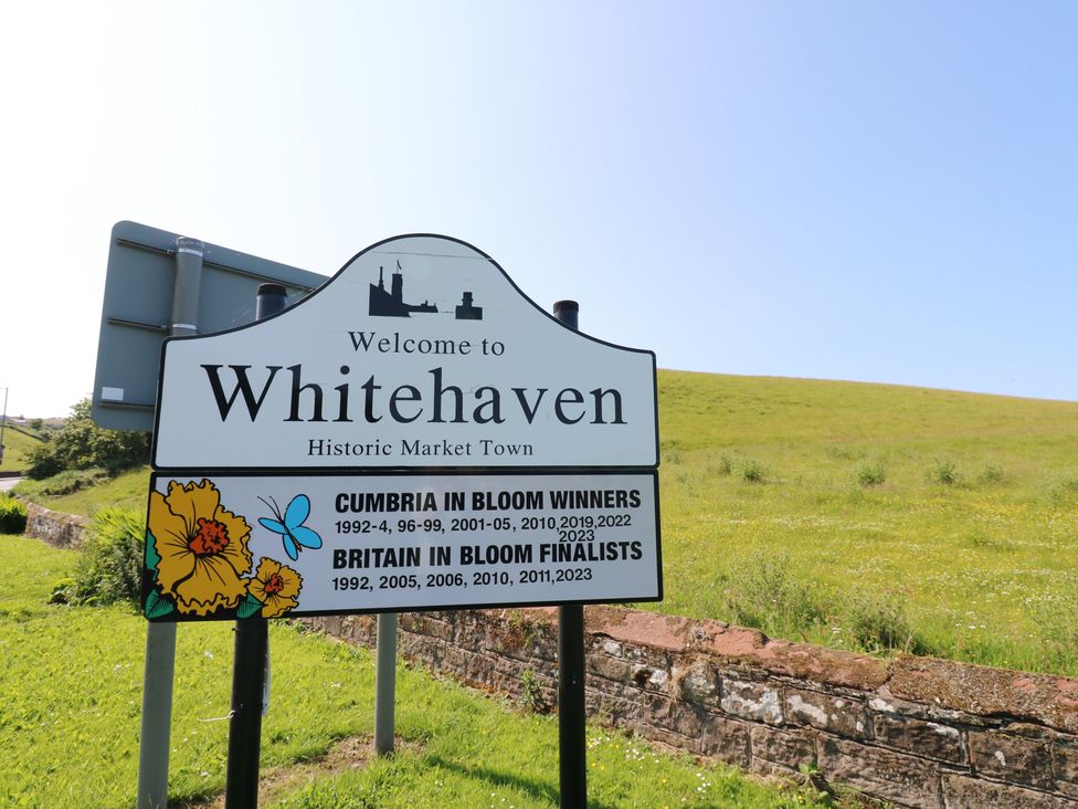A welcome sign for Whitehaven Historic Market Town with information on awards in Cumbria at Pears Suite, Whitehaven