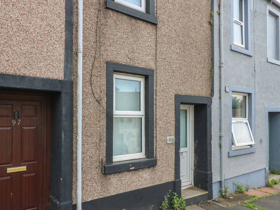 Exterior wall with front door and house number at Holly House in Whitehaven