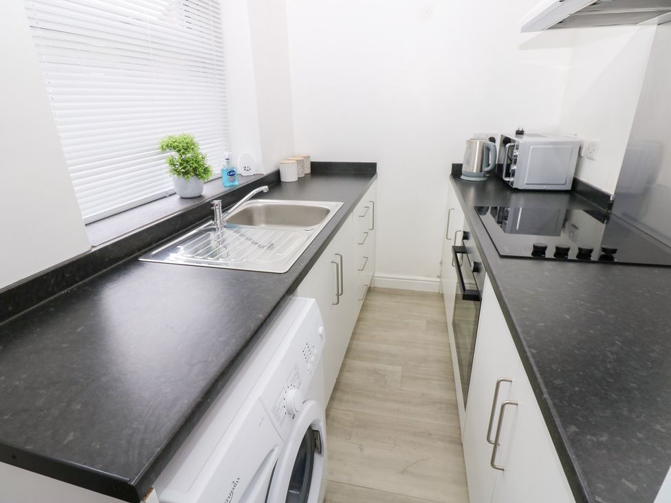 A kitchen with a sink and appliances at Holly House in Waberthwaite