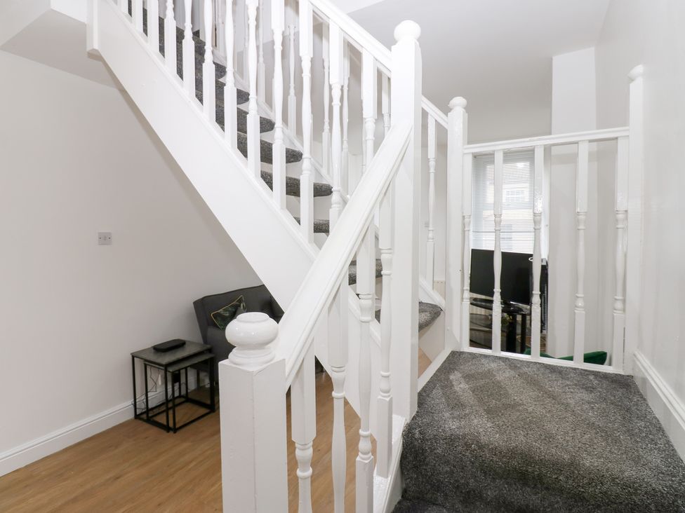 A staircase with a landing and furniture at Holly House in Waberthwaite