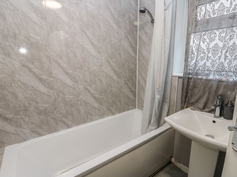 A bathroom with a bathtub and sink at Lonsdale Street