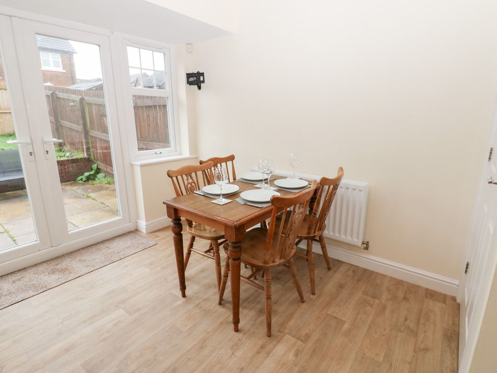 A dining room with a table and chairs at Lingla House Frizington
