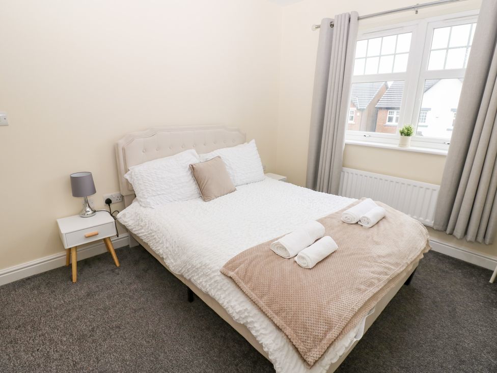 A bedroom with a bed and a bedside table at Lingla House in Frizington