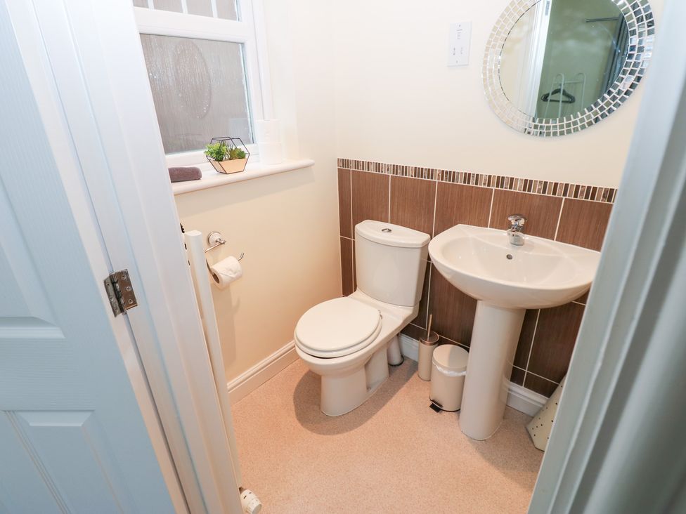 A bathroom with a toilet and sink at Lingla House in Frizington