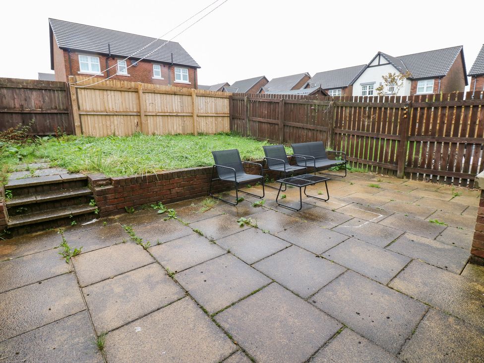 A garden area with patio and chairs at Lingla House in Frizington