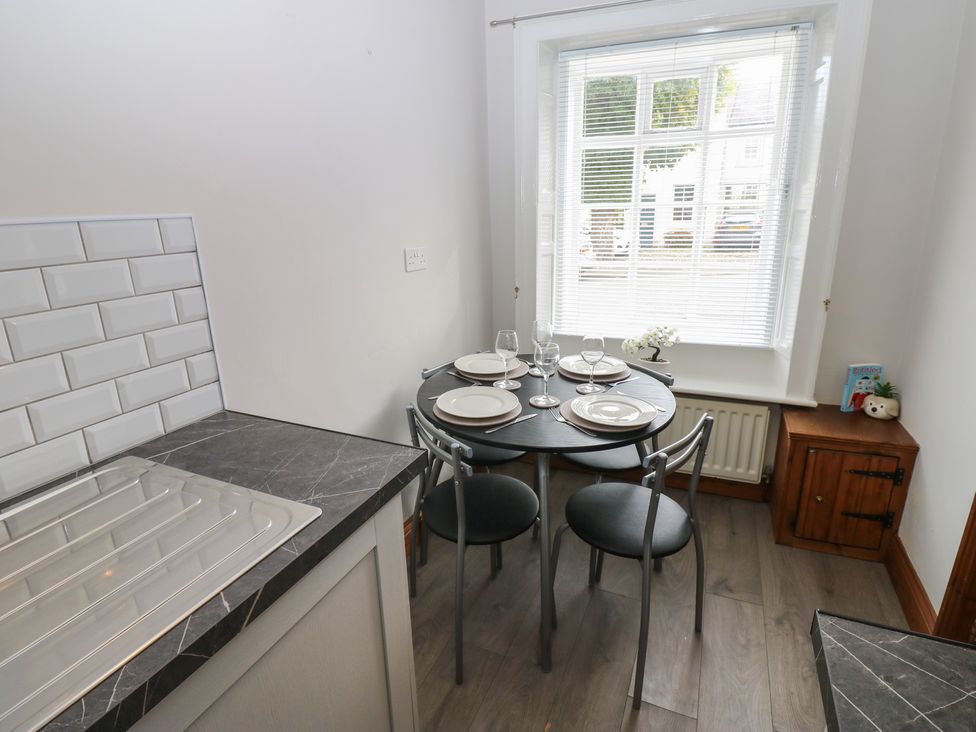 A kitchen with a dining table set at Kirkgate Cottage Cockermouth