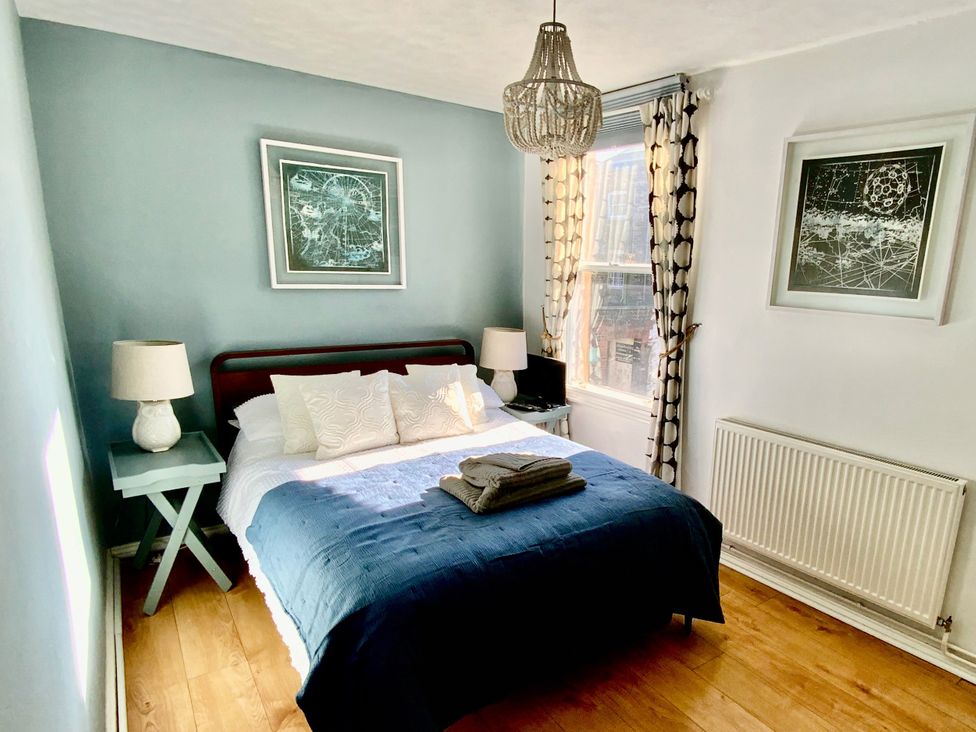 A bedroom with a bed and bedside table at Corner View in Broadstairs