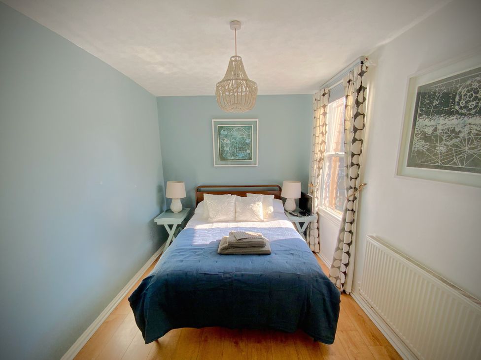 A bedroom with a bed and bedside tables at Corner View in Broadstairs