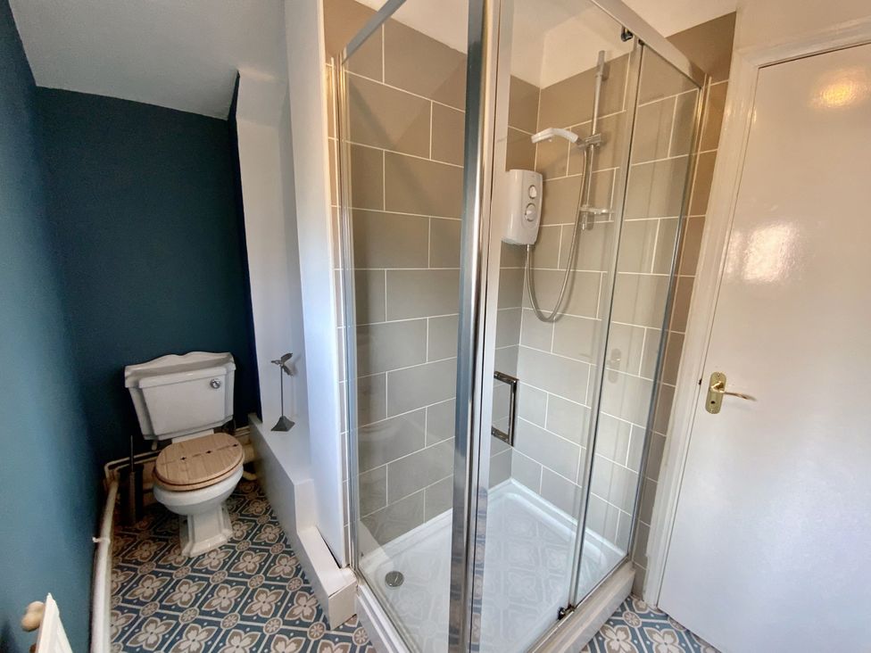 A bathroom with a shower and toilet at Corner View in Broadstairs