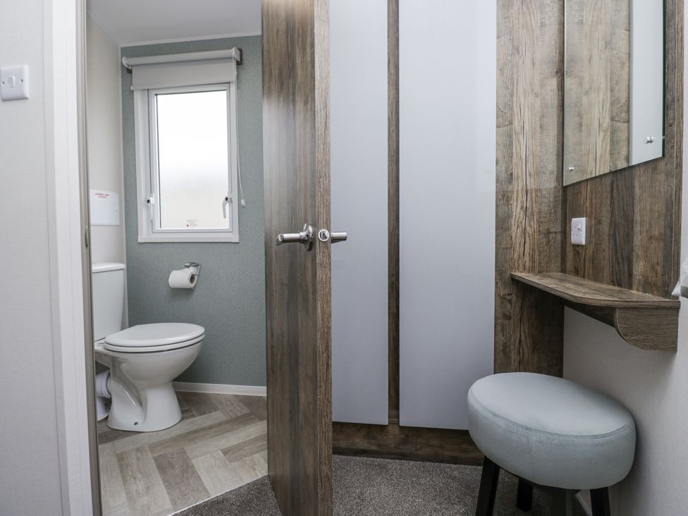 A bathroom with a toilet and sink at Puffin in St Bees
