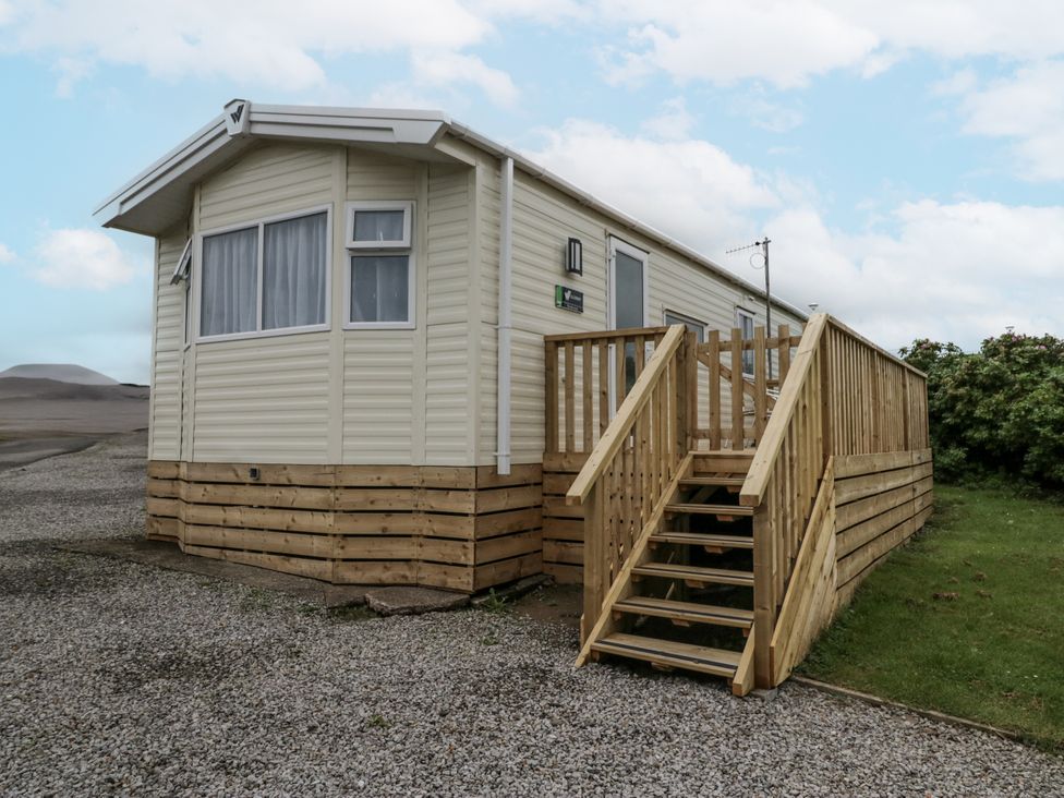 A mobile home with wooden steps in St Bees at Puffin