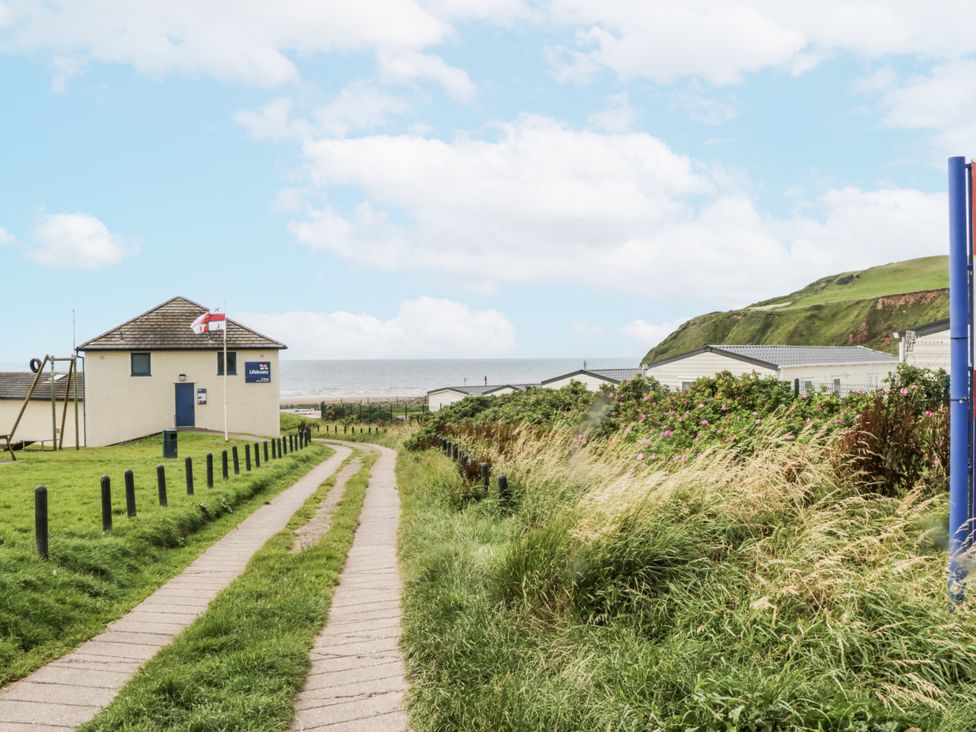 A coastal path leading to a building near the sea at Puffin in St Bees