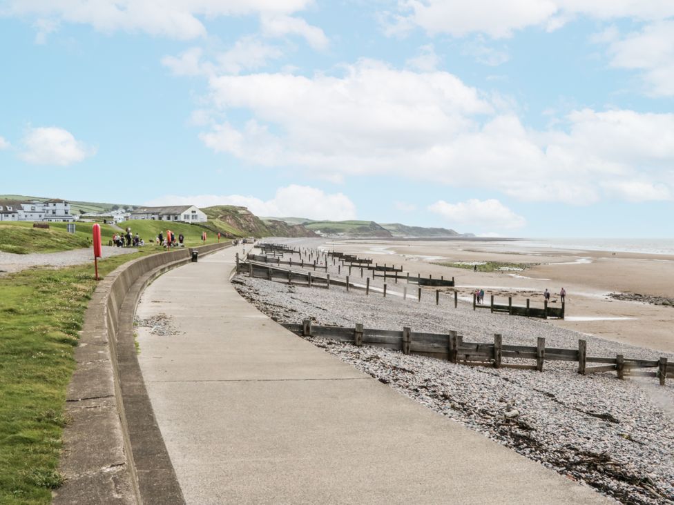 A beach with a path alongside the sea at Puffin in St Bees