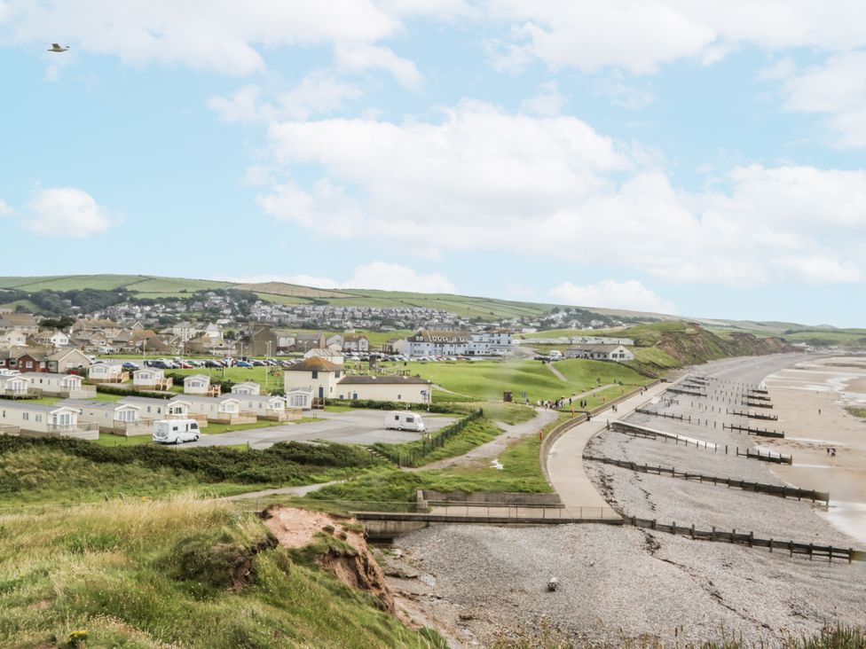 A view of caravans and beach with cliffs at Puffin in St Bees