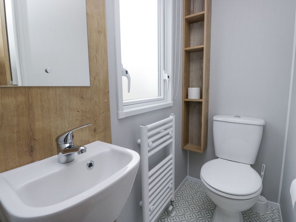 A bathroom with sink and toilet at Sandpiper in St Bees