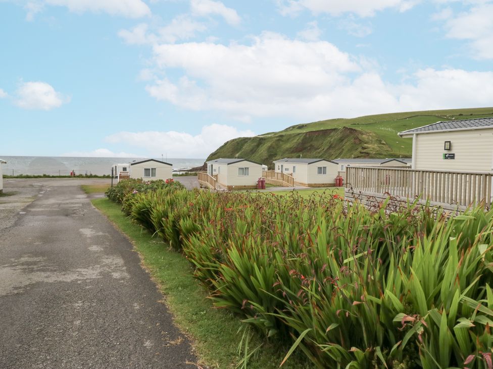 An outdoor area with caravans and a road at Sandpiper in St Bees