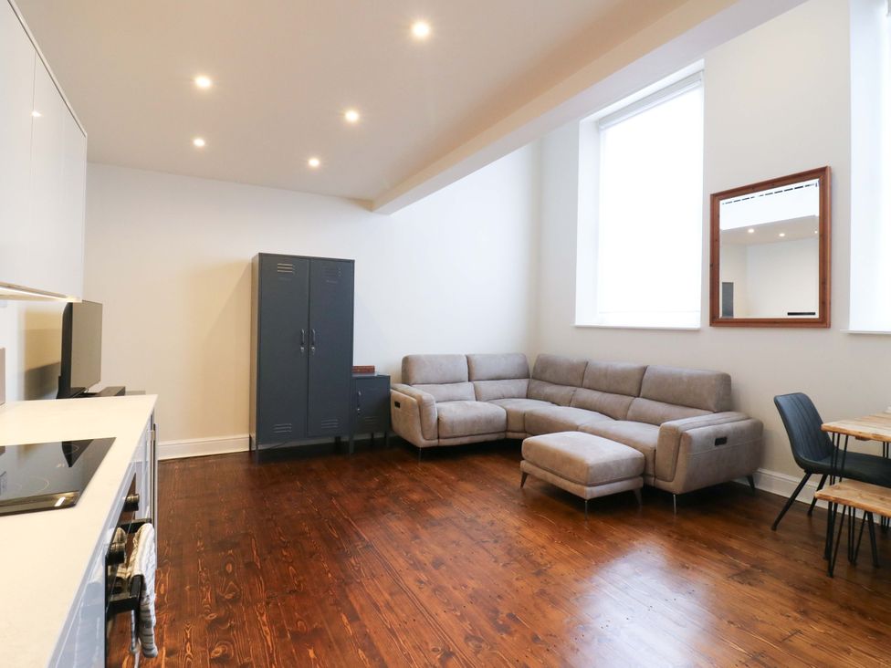 A living room with a sofa and television at Woolwich Apartment in Woolwich