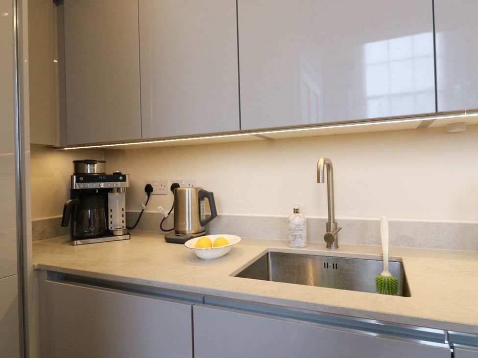 A kitchen with a coffee maker and kettle at Woolwich Apartment in Woolwich