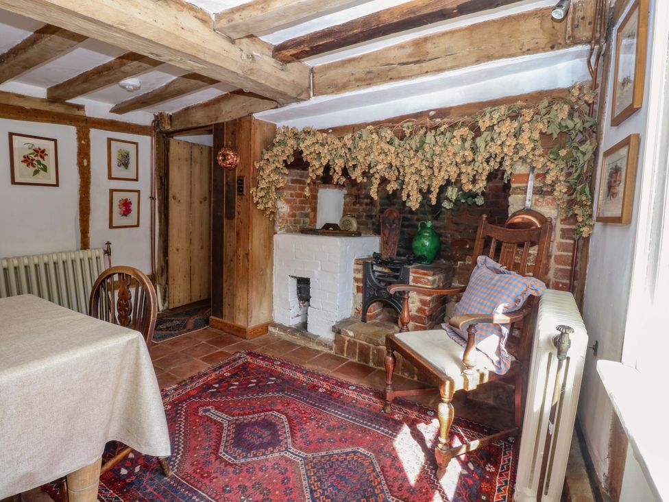 A dining room with a fireplace and wooden furniture at Bank House