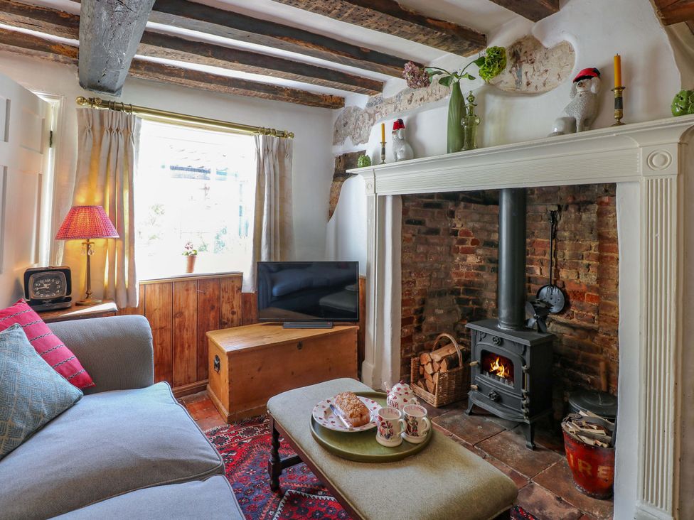 A living room with a fireplace and sofa at Bank House