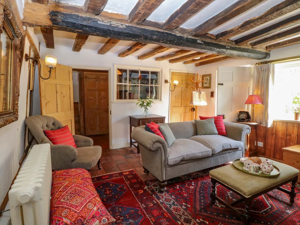 A living room with a sofa, armchair, and coffee table at Bank House