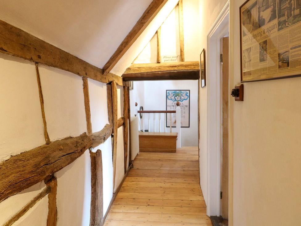A hallway with wooden beams and a staircase at Bank House