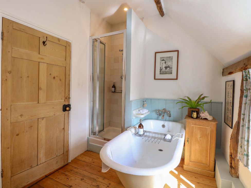 A bathroom with a tub and shower at Bank House