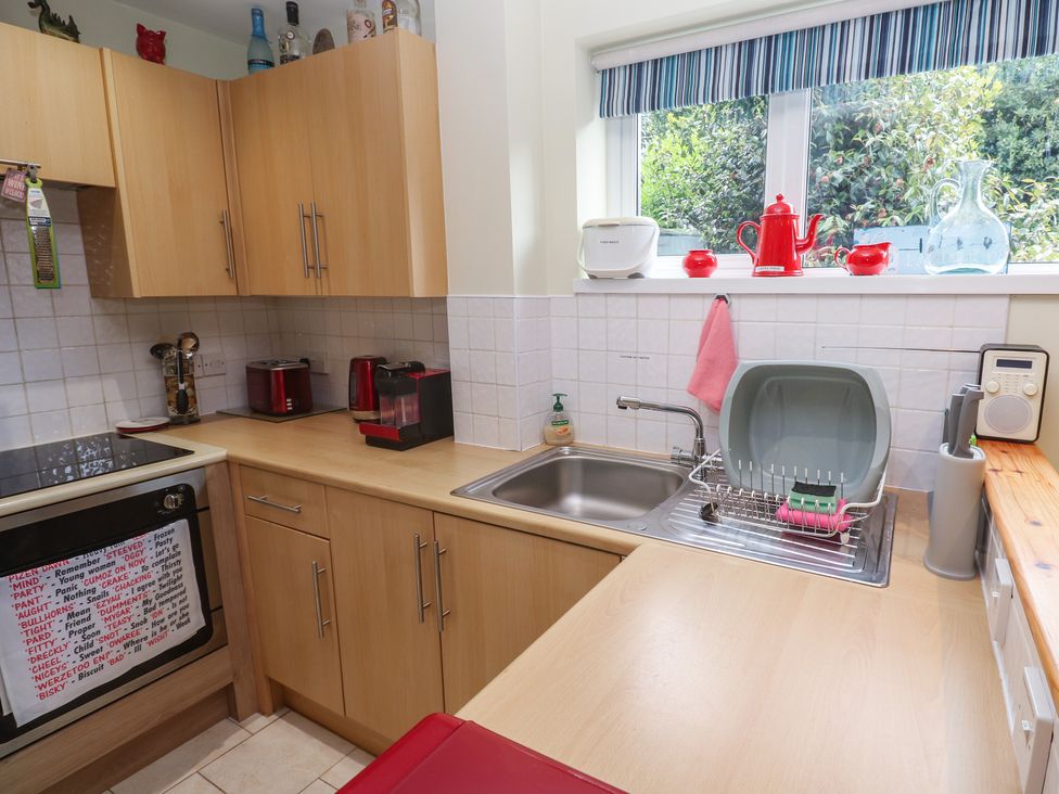 A kitchen with a sink and stove at Mini Mena in St Austell
