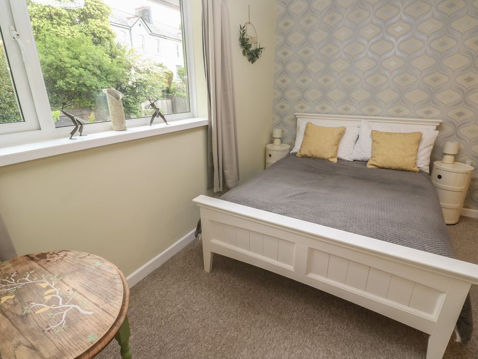 A bedroom with a bed and decorative elements at Mini Mena in St Austell