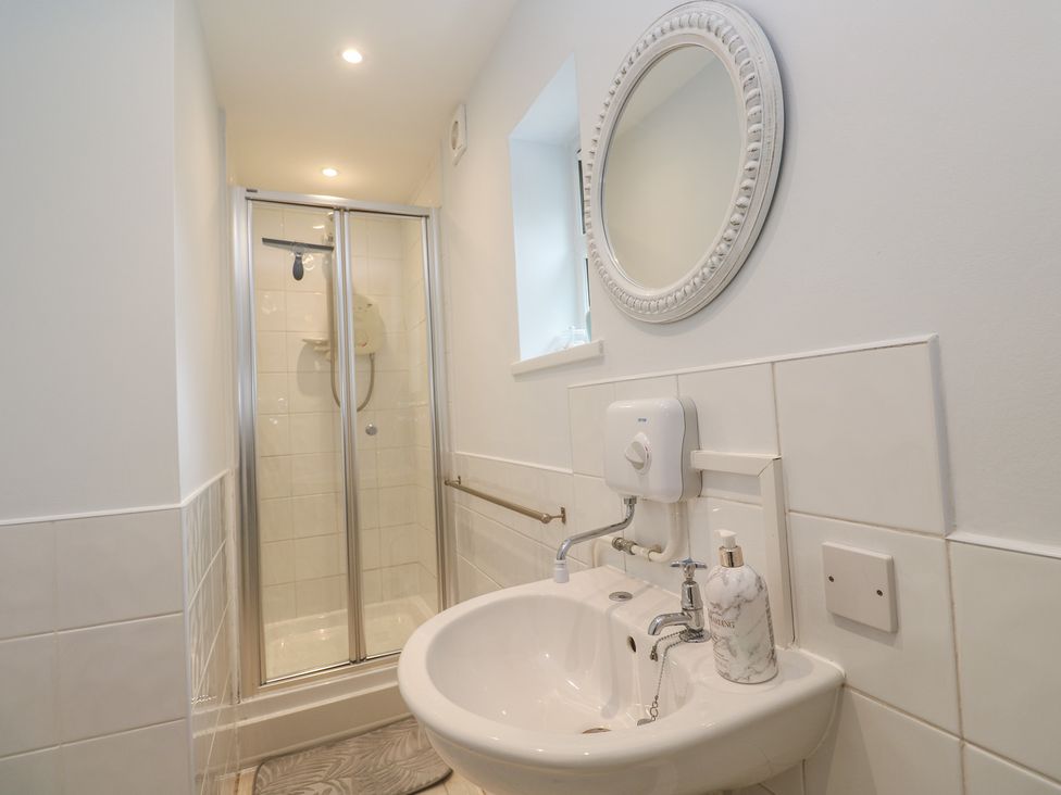A bathroom with a sink and shower at Mini Mena in St Austell