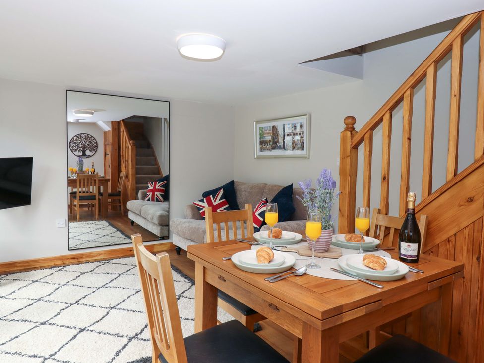 A dining room with a table set for breakfast at Church Barn in Sutcombe near Bradworthy