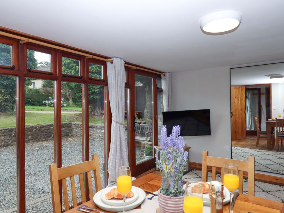 A dining room with a table set for breakfast at Church Barn Sutcombe near Bradworthy