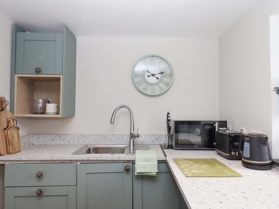 A kitchen with a sink and appliances at Church Barn in Sutcombe near Bradworthy