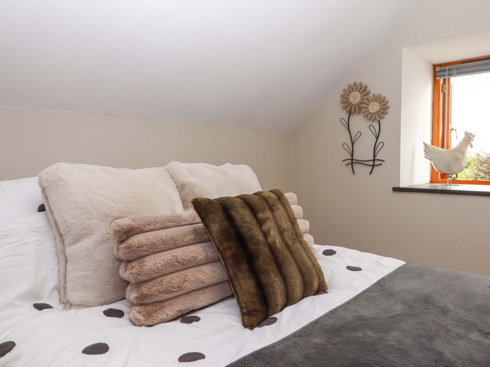A bedroom with pillows on a bed at Church Barn in Sutcombe near Bradworthy