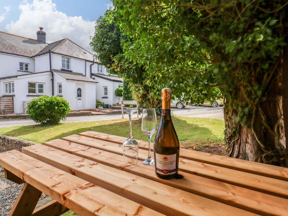 A table with a bottle of Prosecco and glasses at Church Barn Sutcombe near Bradworthy