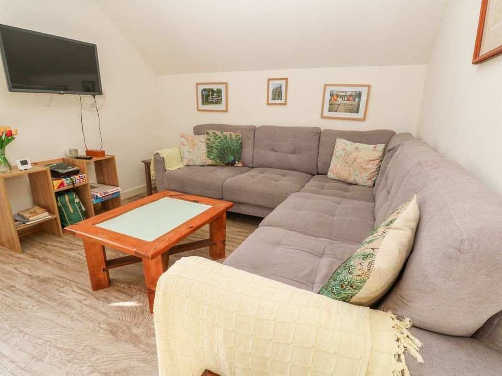 A living room with a sofa and coffee table at Five Elements Barn in Truro