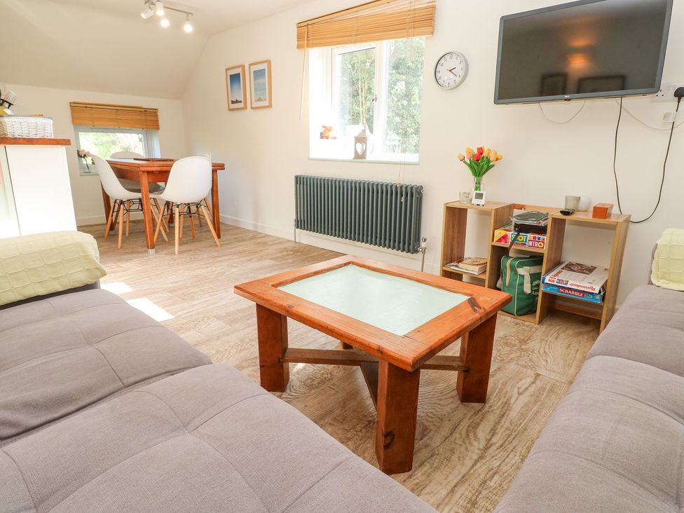 A living room with a table and chairs at Five Elements Barn in Truro