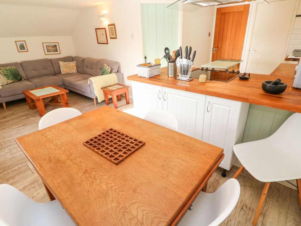 A living area with a sofa and dining table at Five Elements Barn in Truro