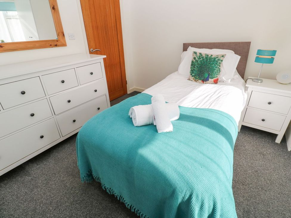 A bedroom with a bed and dresser at Five Elements Barn in Truro