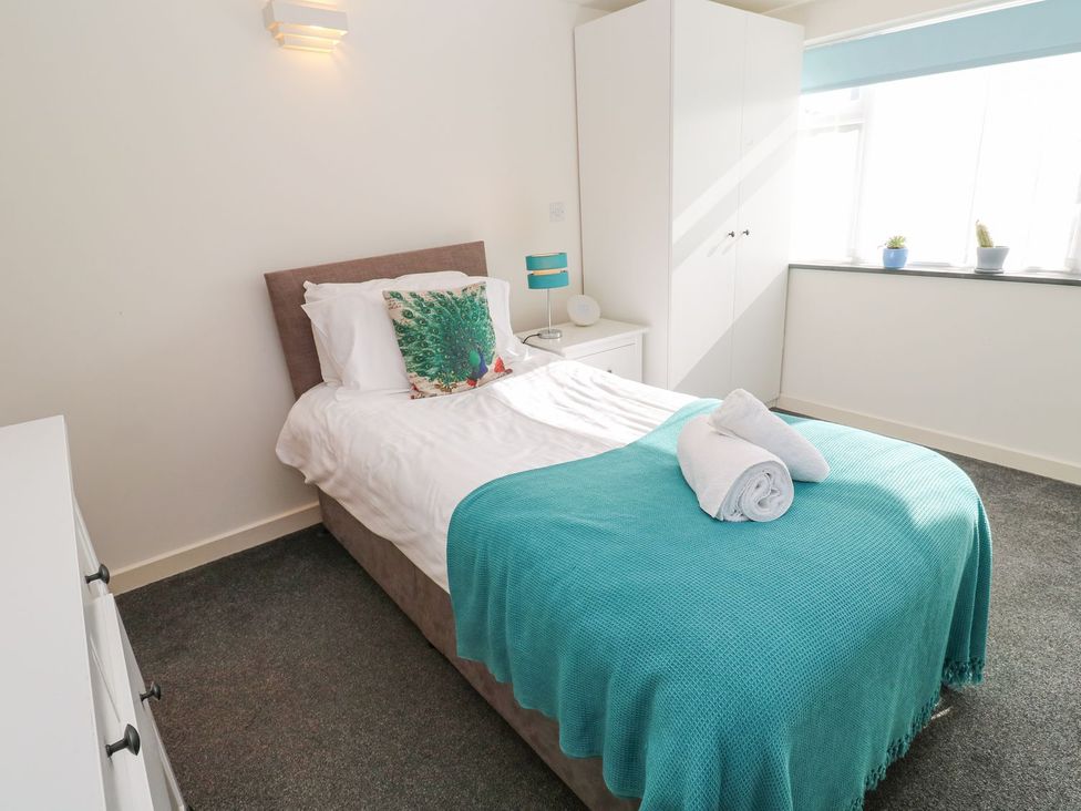 A bedroom with a bed and wardrobe at Five Elements Barn in Truro