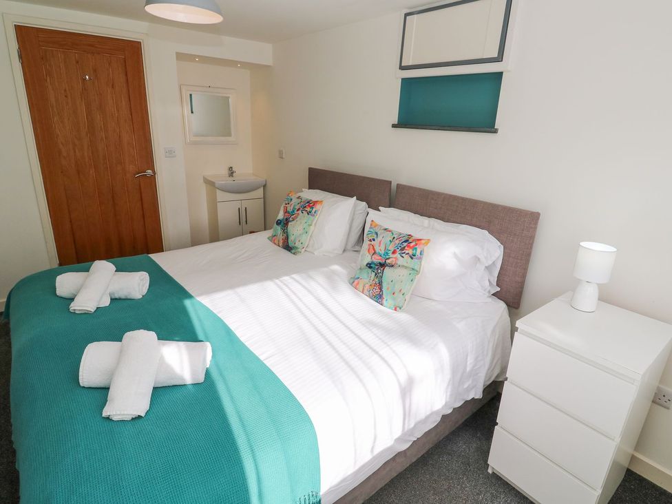 A bedroom with a double bed and nightstand at Five Elements Barn in Truro