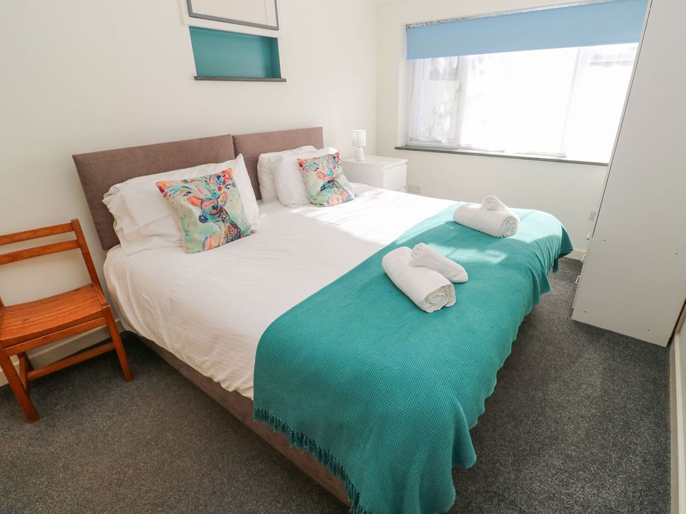 A bedroom with a bed and bedside table at Five Elements Barn Truro