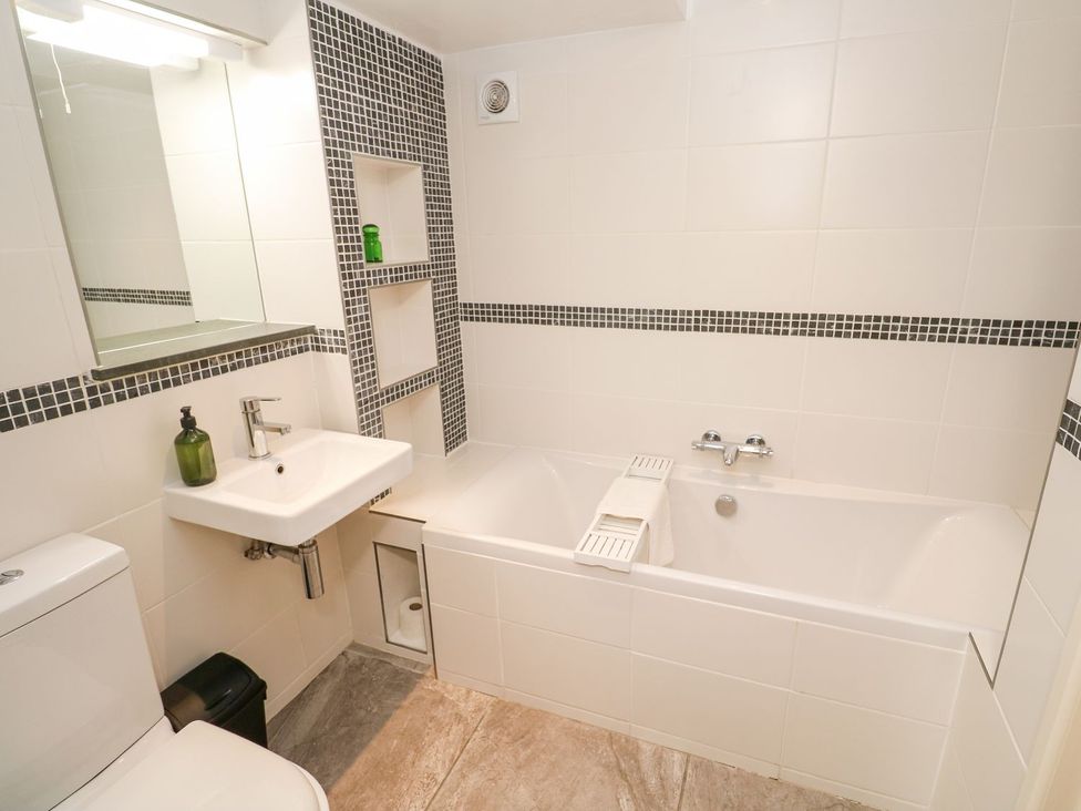 A bathroom with a bathtub and sink at Five Elements Barn in Truro