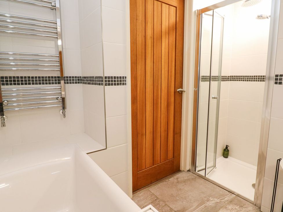 A bathroom with a bathtub and a shower at Five Elements Barn in Truro
