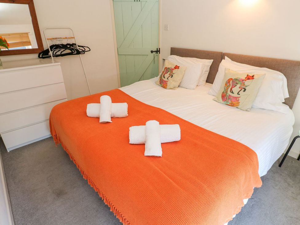 A bedroom with a bed and dresser at Five Elements Barn in Truro