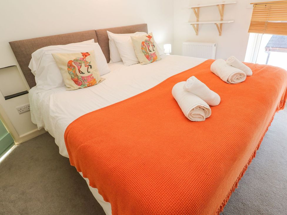 A bedroom with a bed and towels at Five Elements Barn in Truro